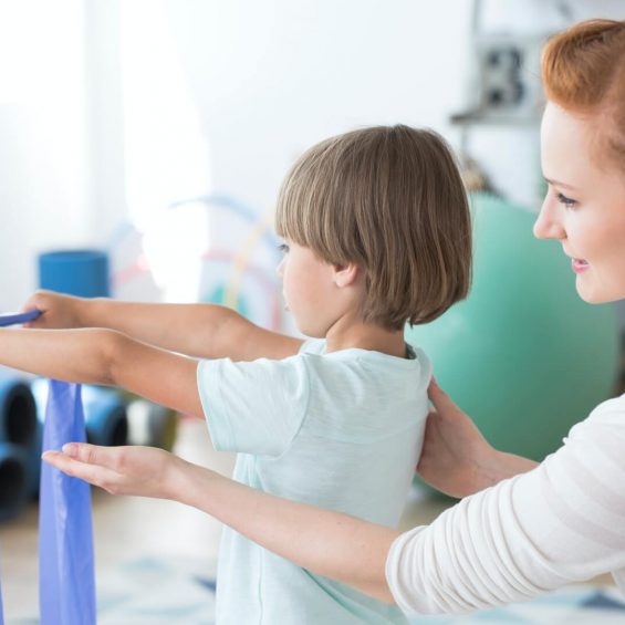 physiotherapist-supporting-kid.jpg